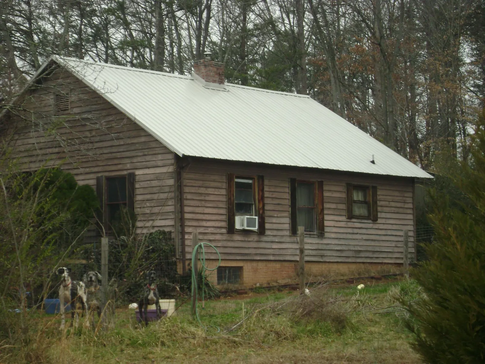 White metal roof on an old wood sided farmhouse, from a Metal Roof Installation job in Mechanicville
